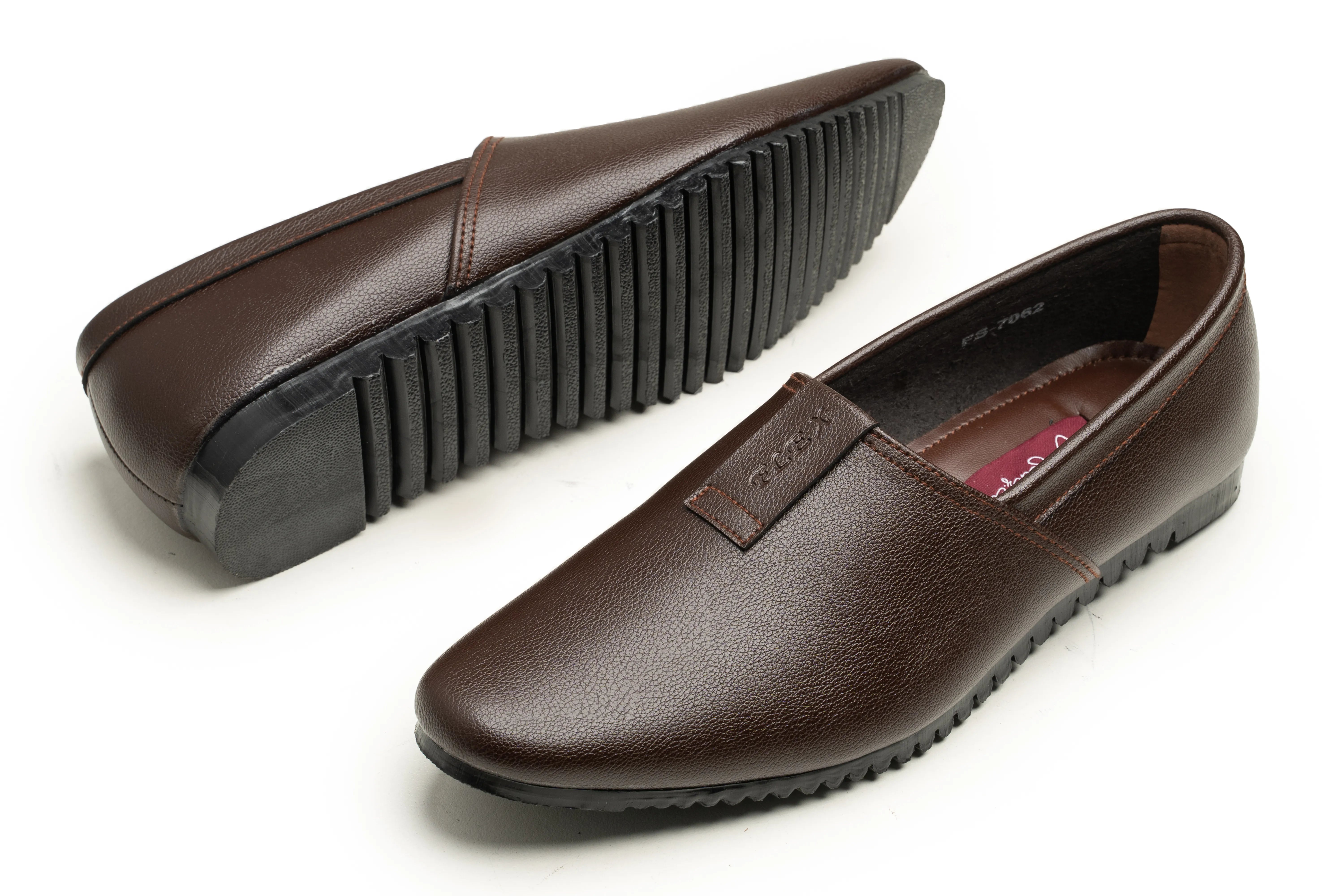 A pair of dark brown leather slip-on loafers shown on a white background, with one shoe displaying the textured black sole and the other showing the interior.