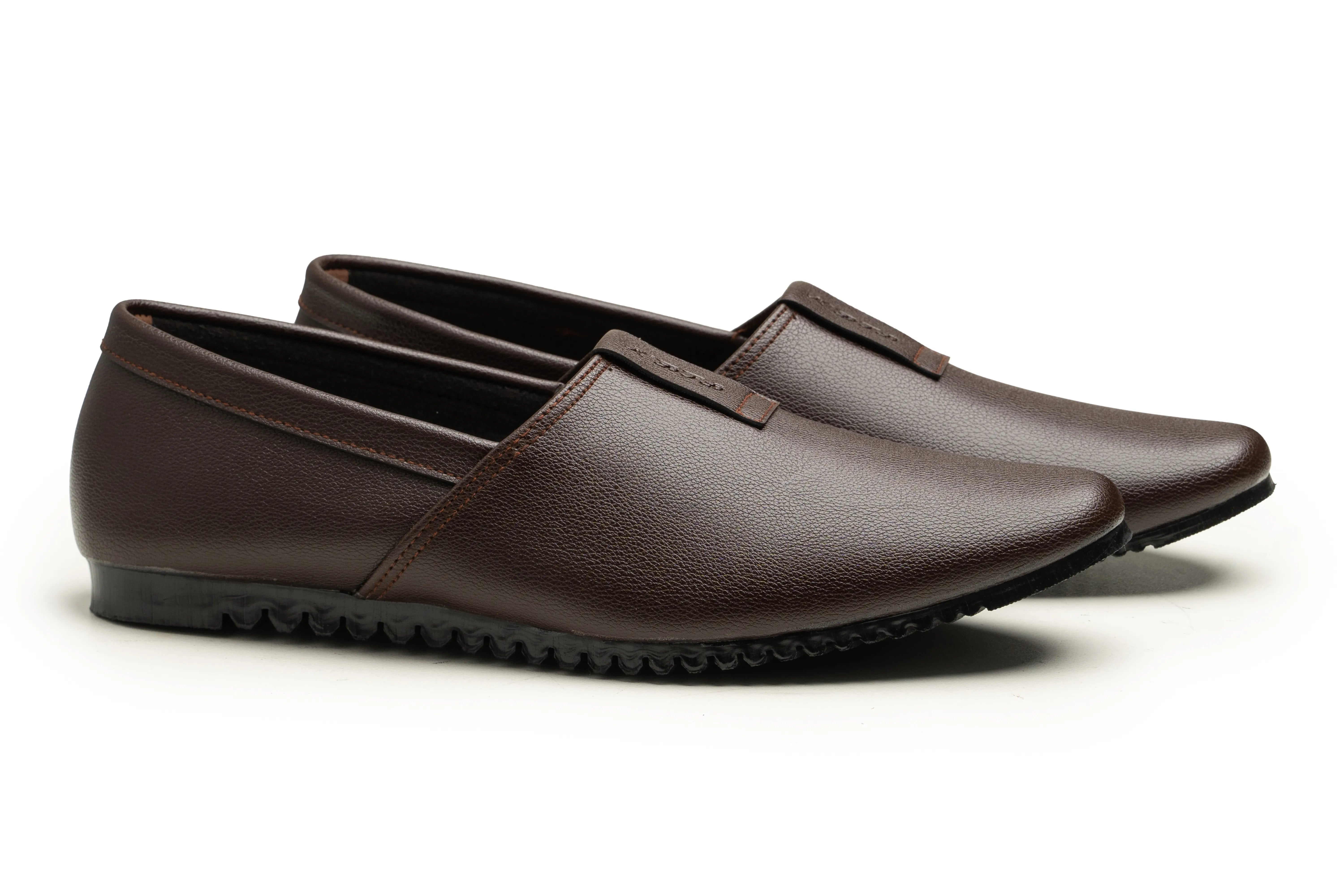 A pair of dark brown leather slip-on loafers with a textured black sole, displayed on a clean white background.
