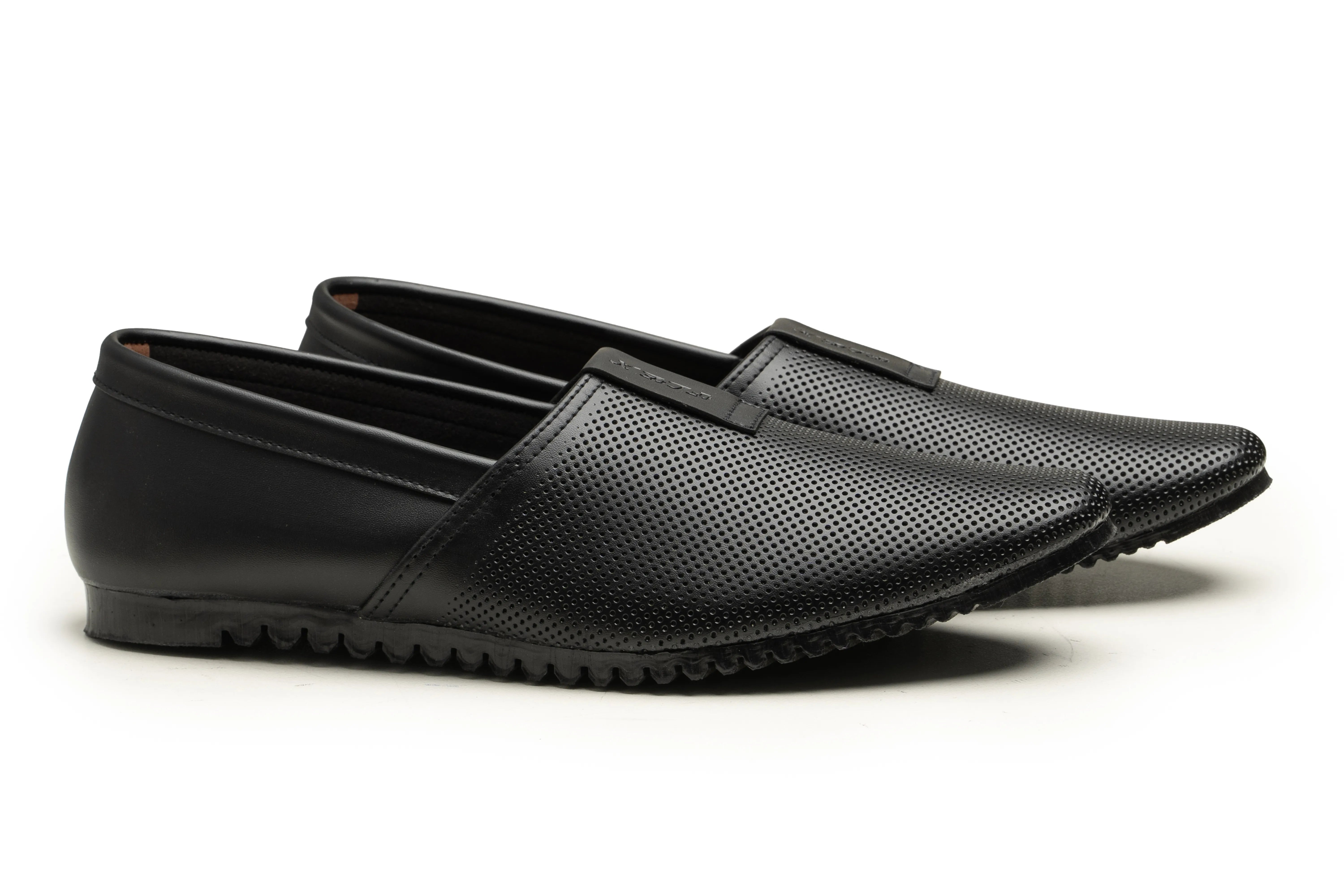 A pair of black leather slip-on loafers with perforated detailing on the upper, shown from a side profile against a white background.
