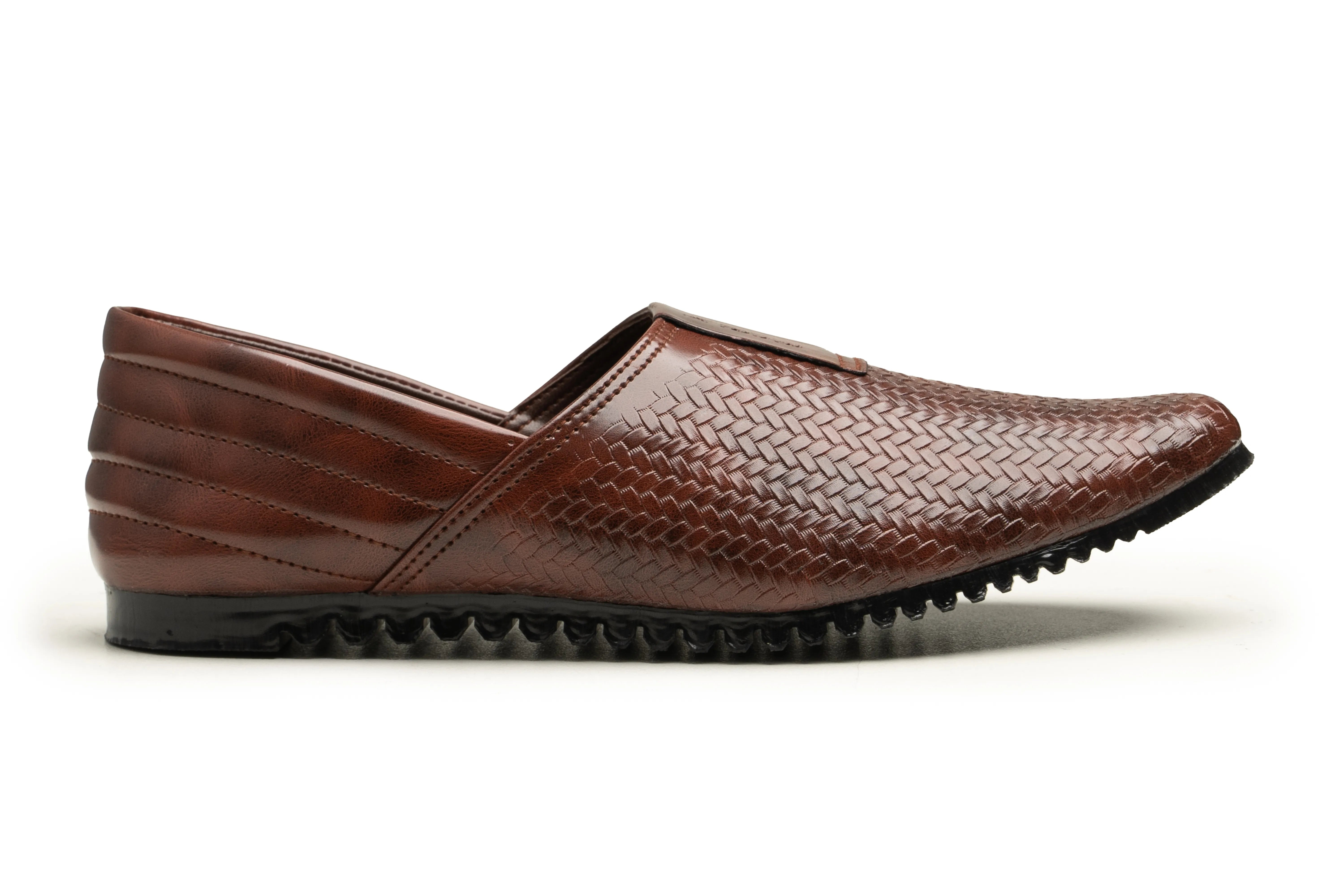 A brown leather slip-on shoe with a textured woven pattern on the upper and a black treaded sole, shown in profile against a white background.