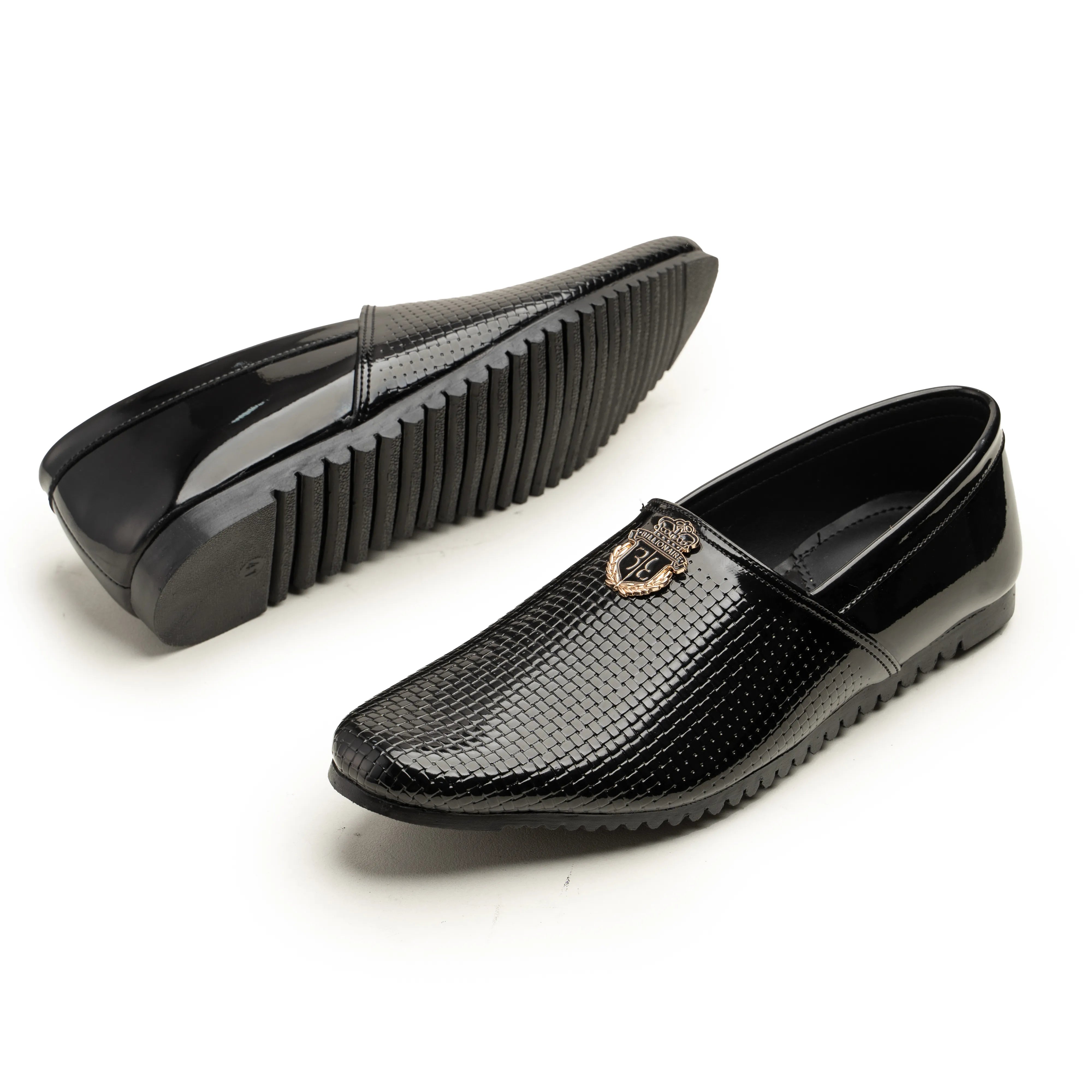 A pair of men's black slip-on loafers with a glossy textured reptile pattern, featuring a small gold-tone horsebit detail on the side. One shoe is shown from the top view displaying the textured toe and side profile, while the other is shown from the side profile displaying the ridged sole.