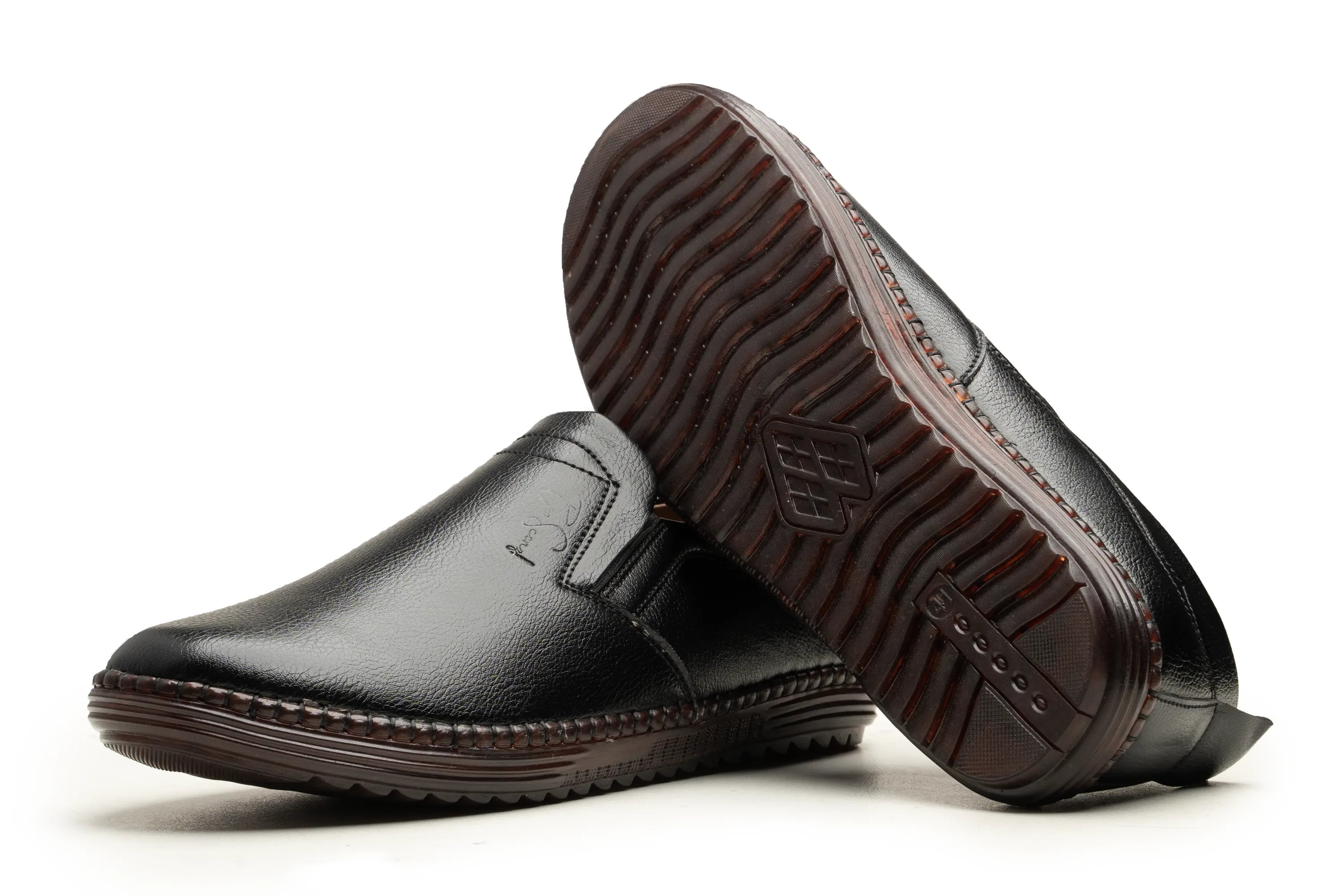 A pair of men's slip-on loafers in black leather, with one shoe standing upright and the other tilted on its side to display the textured brown outsole.
